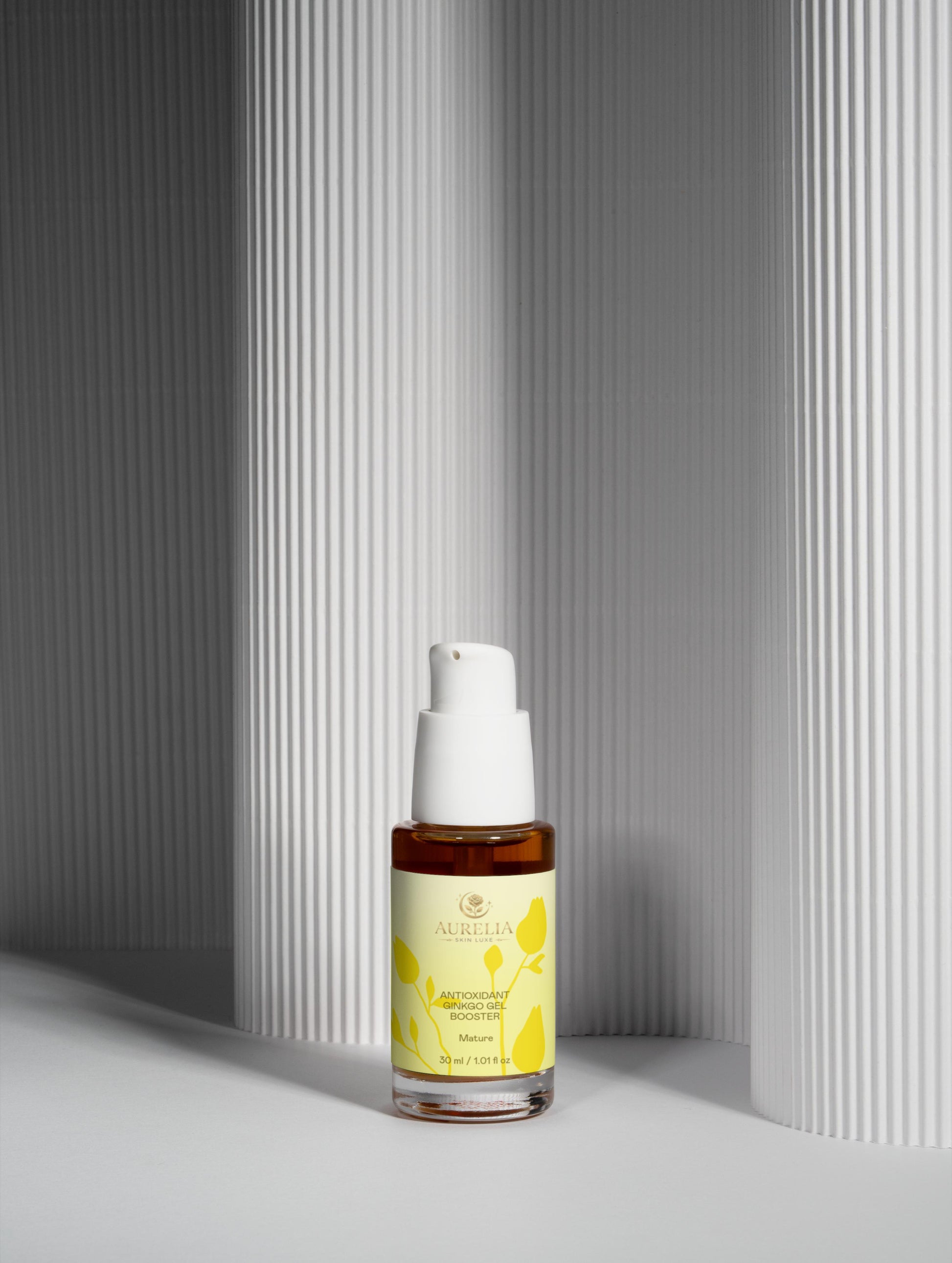 Skincare serum bottle with yellow label on a gray background