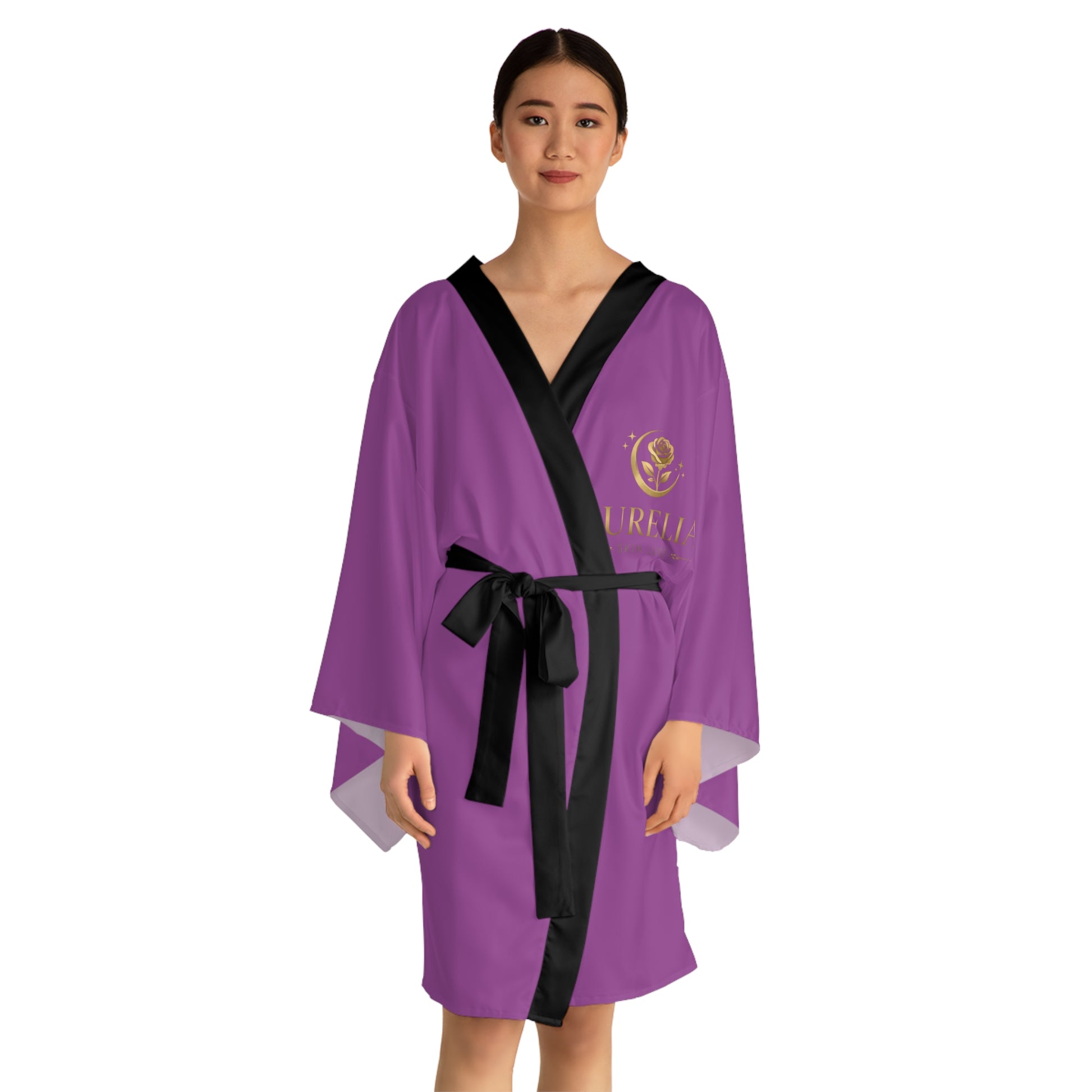 Person wearing a purple robe with a black belt on a white background