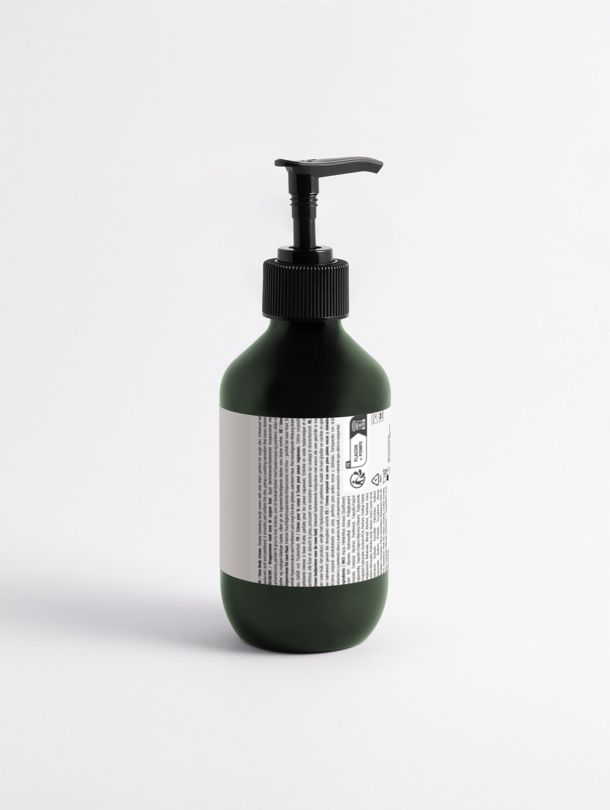 Green bottle with pump and label on a white background