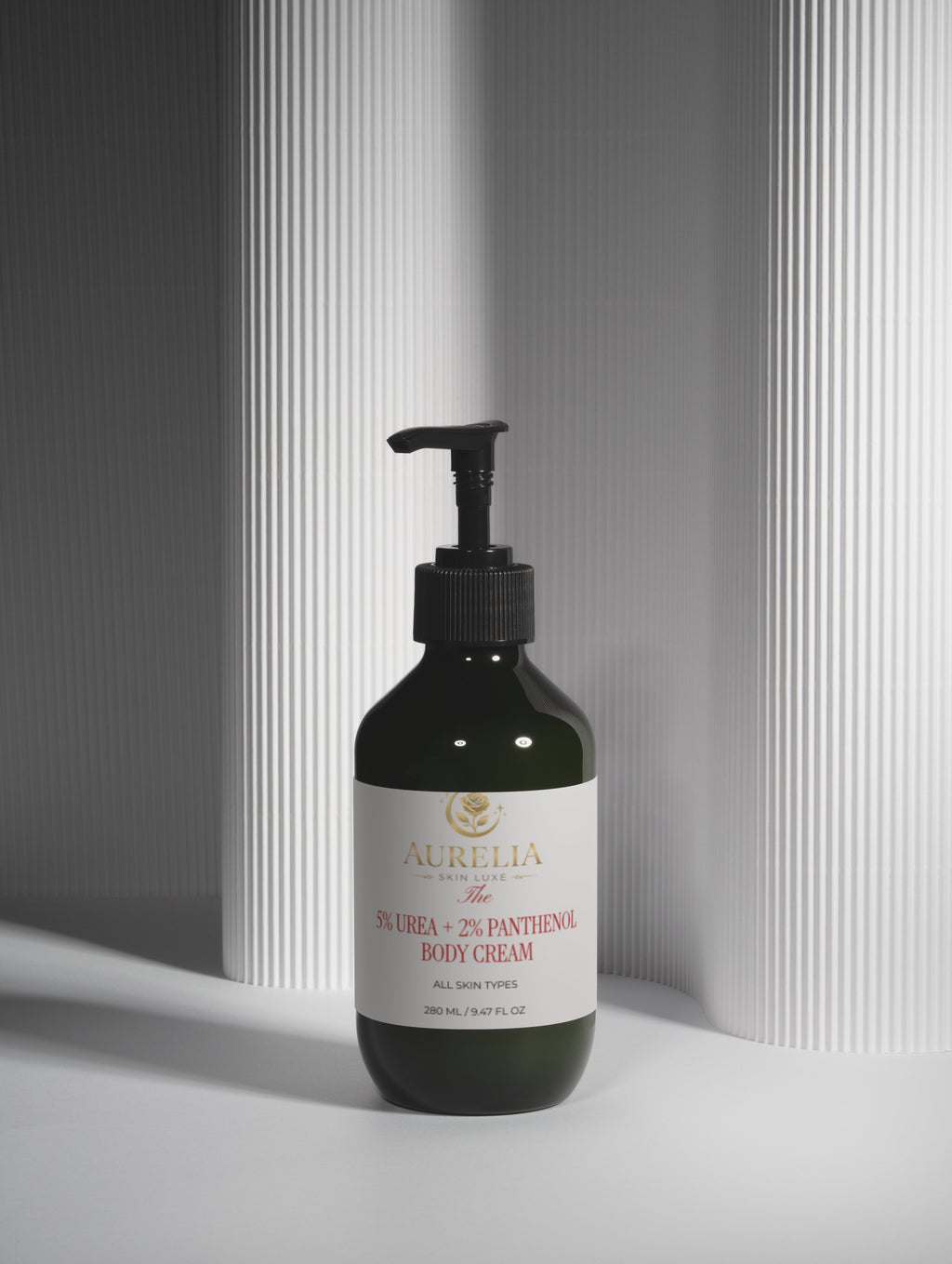 Black bottle of body cream with pump on a light gray background